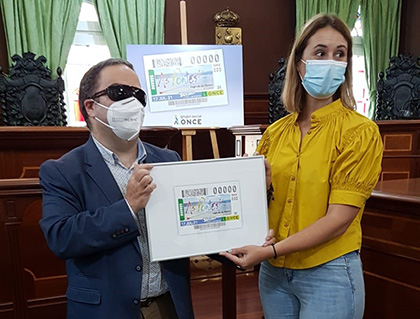 Carlos Fernández Lamigueiro y Elena López Seco, con una copia enmarcada del cupón